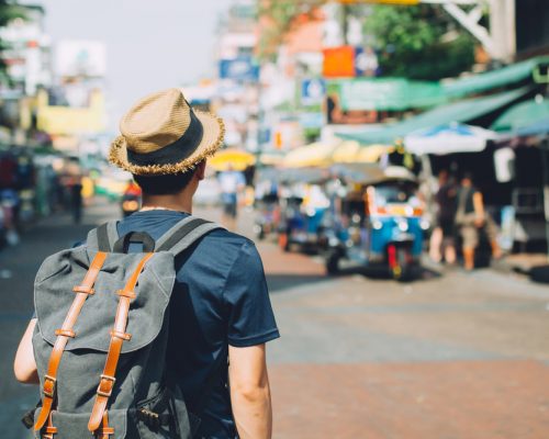 Young,Asian,Traveling,Backpacker,In,Khaosan,Road,Outdoor,Market,In